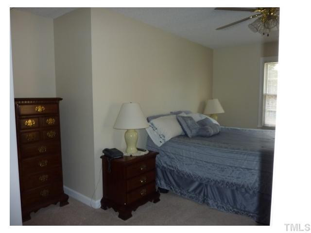 5407 Fortunes Ridge Drive Durham, NC 27713 - Photo 10 of 22 a bed room with a bed and a dresser