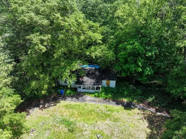 a backyard of a house with a yard and trampoline