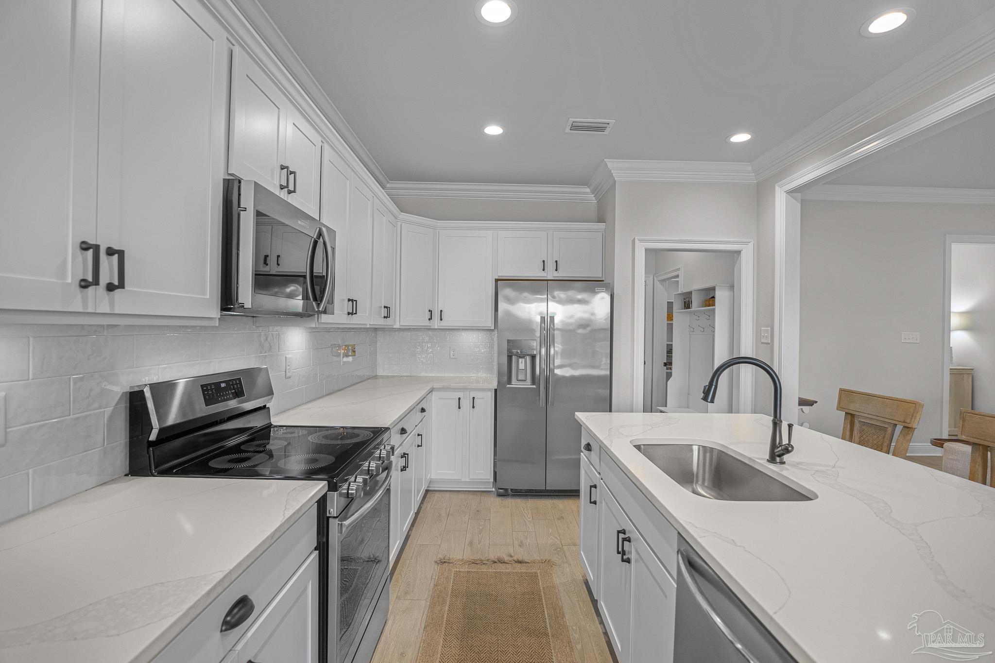 5380 Adeline Circle Pace, FL 32571 - Photo 11 of 35 a kitchen with a sink stove and refrigerator