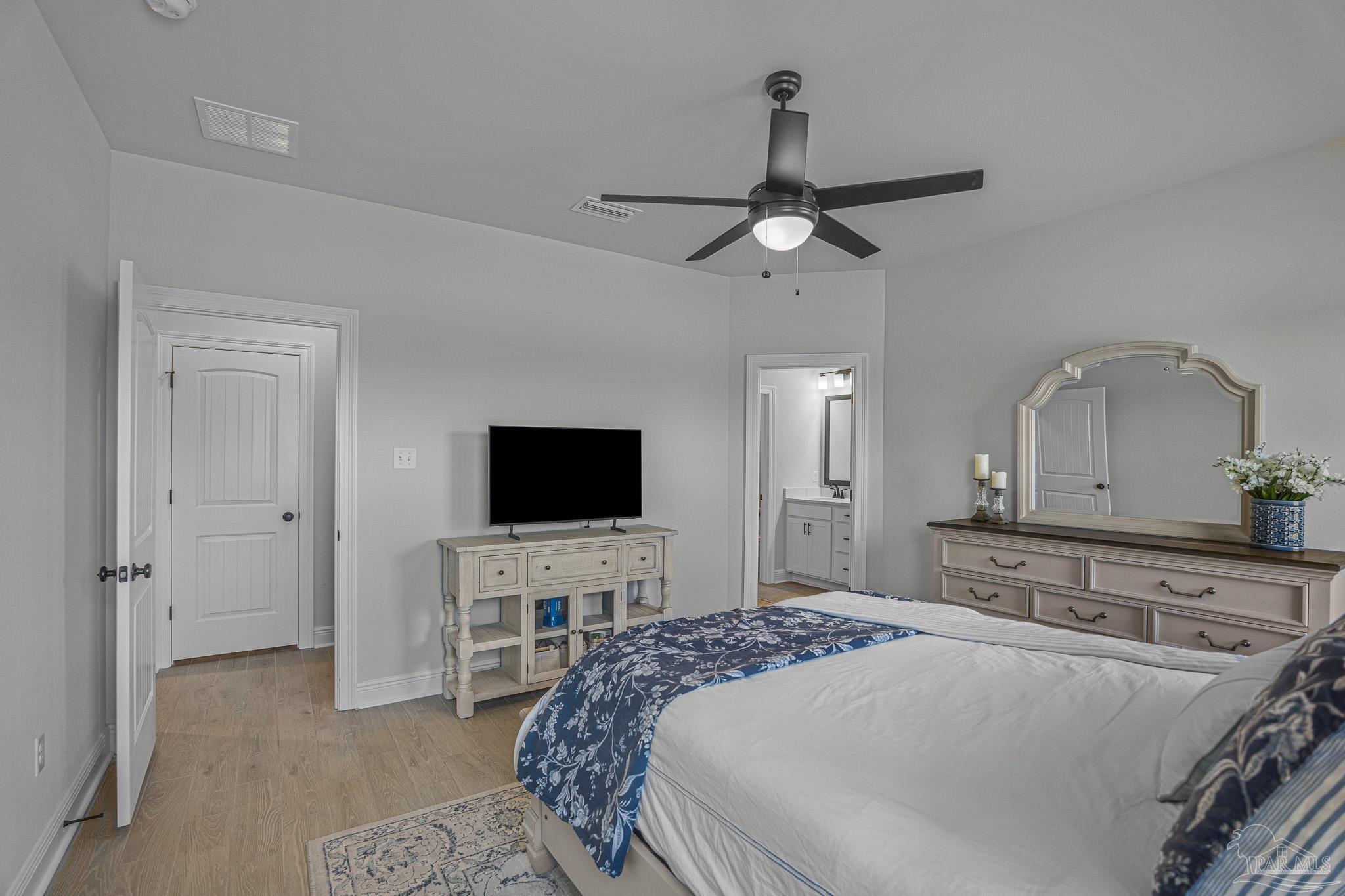5380 Adeline Circle Pace, FL 32571 - Photo 17 of 35 a bedroom with a bed and a flat screen tv