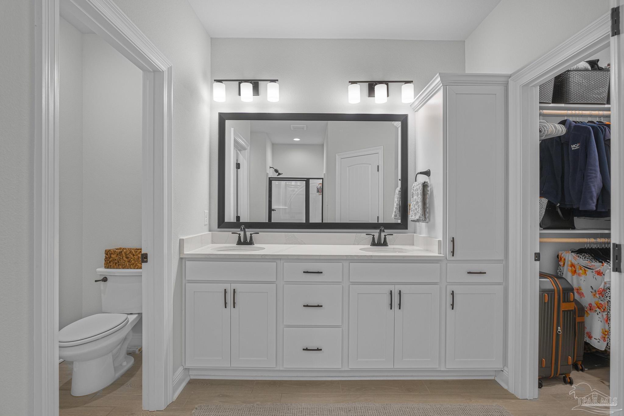 5380 Adeline Circle Pace, FL 32571 - Photo 18 of 35 a bathroom with a granite countertop sink a toilet and a mirror