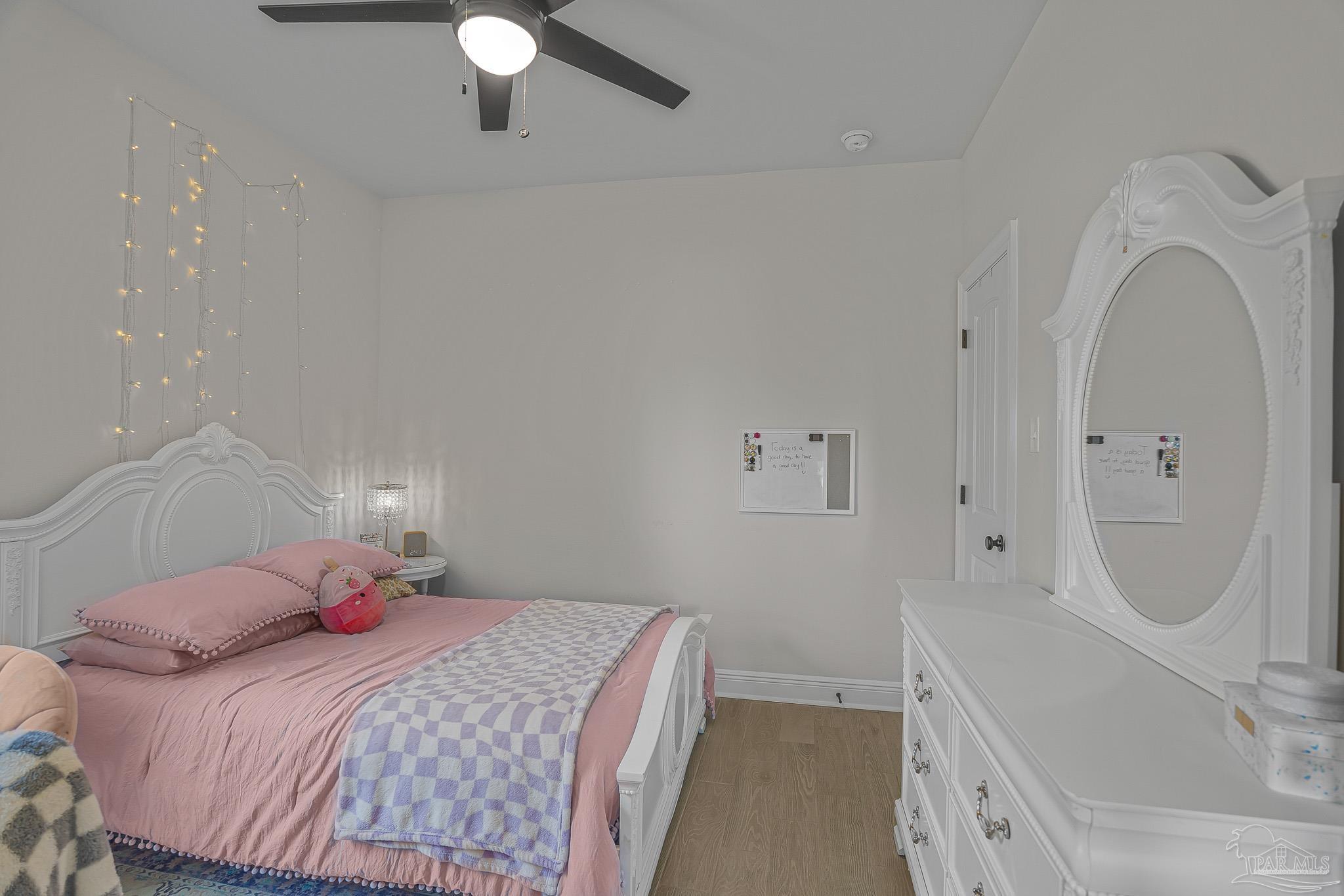 5380 Adeline Circle Pace, FL 32571 - Photo 20 of 35 a bedroom with a bed and a chandelier