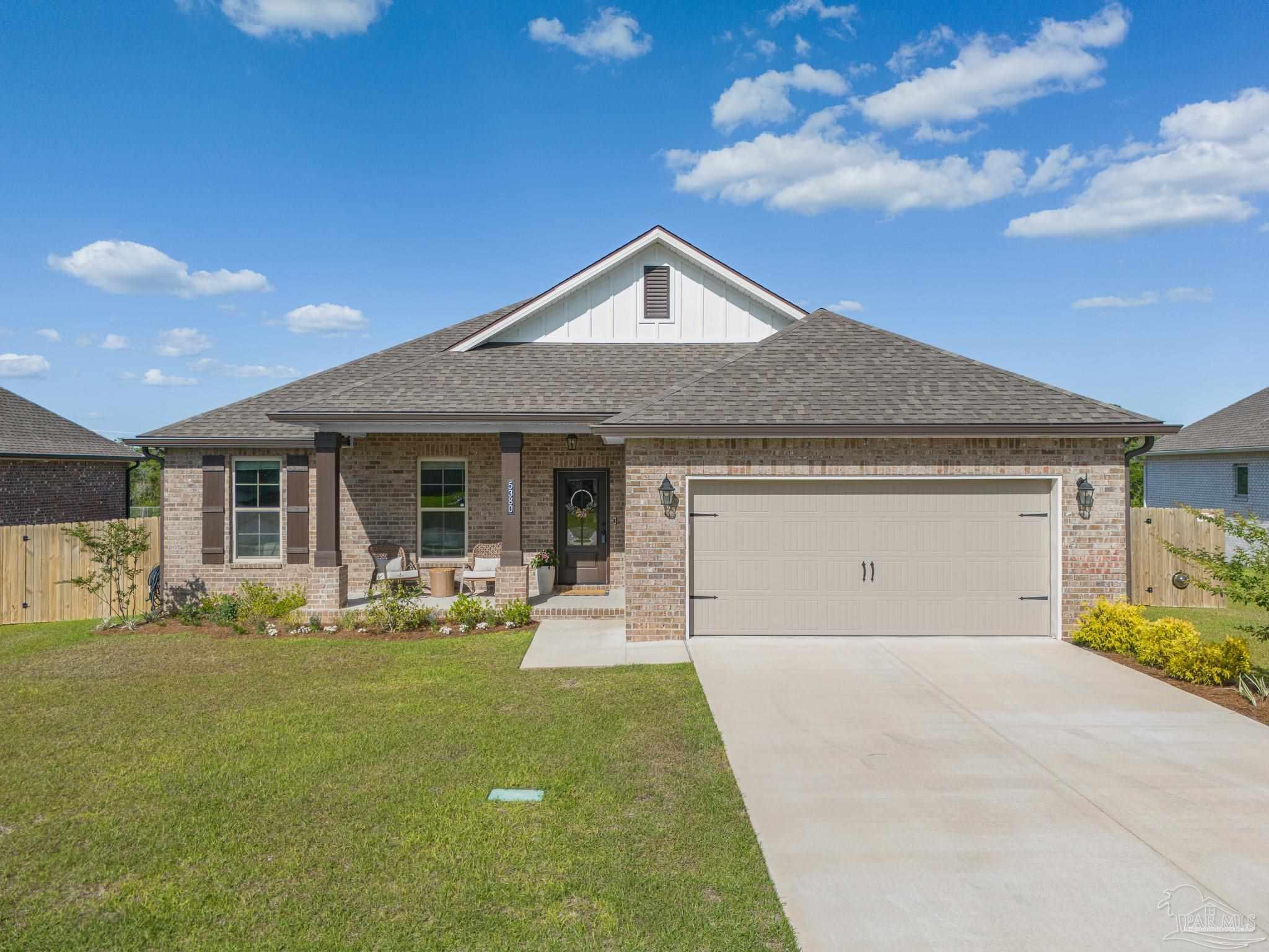 5380 Adeline Circle Pace, FL 32571 - Photo 2 of 35 a front view of a house with swing and porch