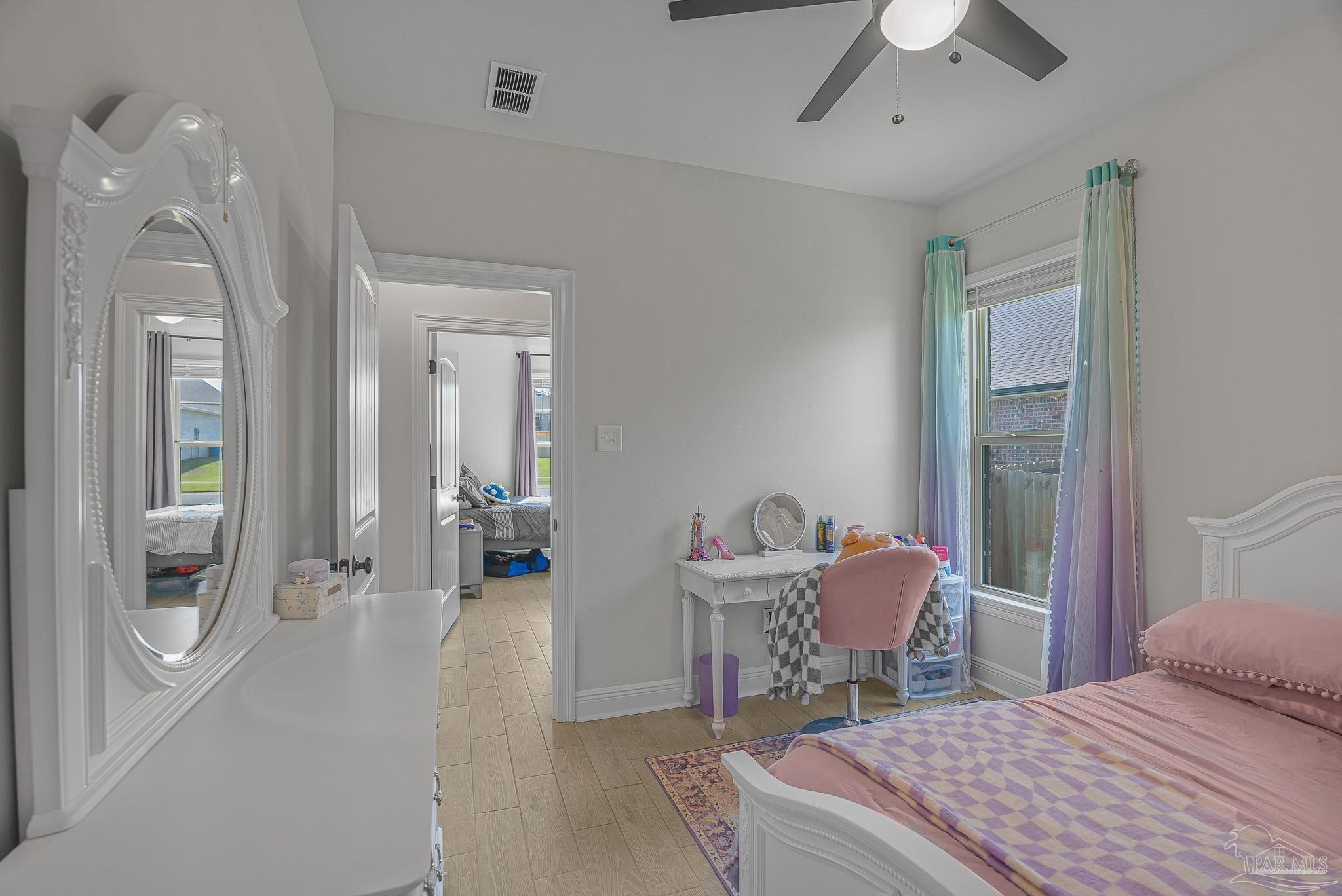 5380 Adeline Circle Pace, FL 32571 - Photo 21 of 35 a bedroom with a bed and a chandelier