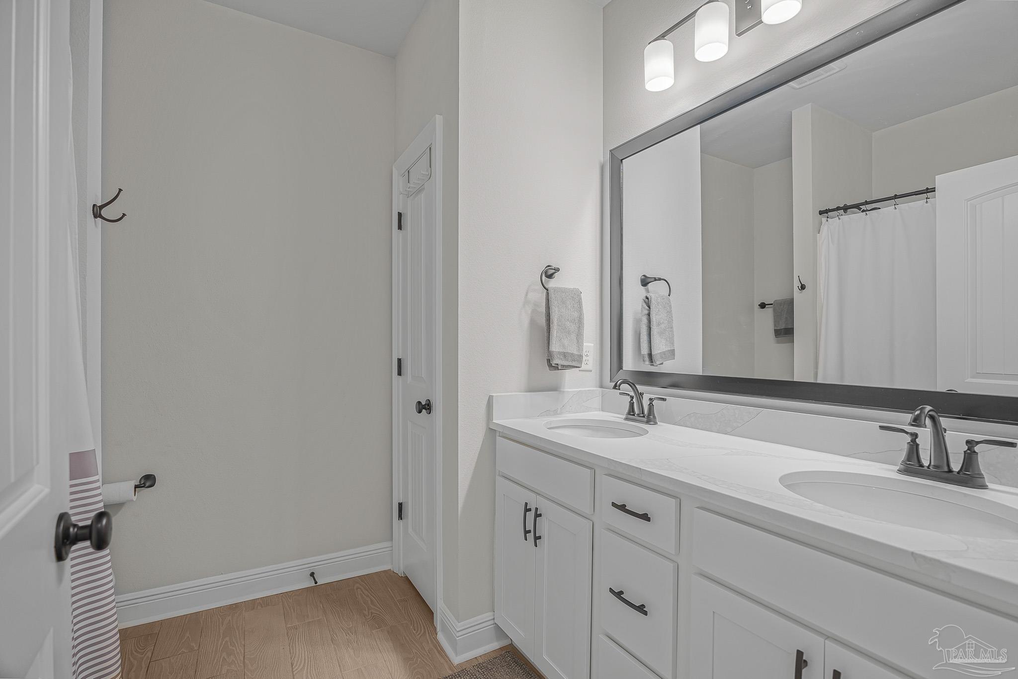 5380 Adeline Circle Pace, FL 32571 - Photo 22 of 35 a bathroom with a sink and a mirror