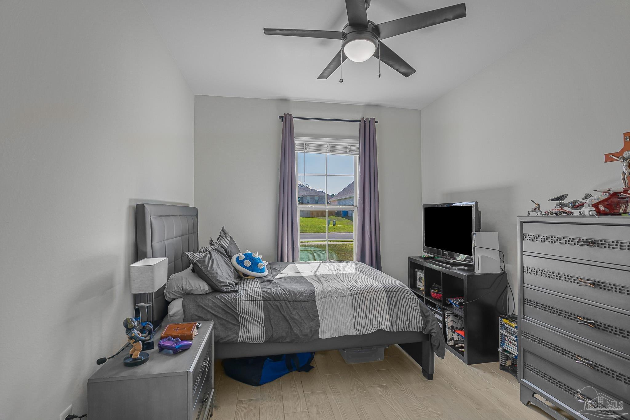 5380 Adeline Circle Pace, FL 32571 - Photo 23 of 35 a bedroom with bed and a window