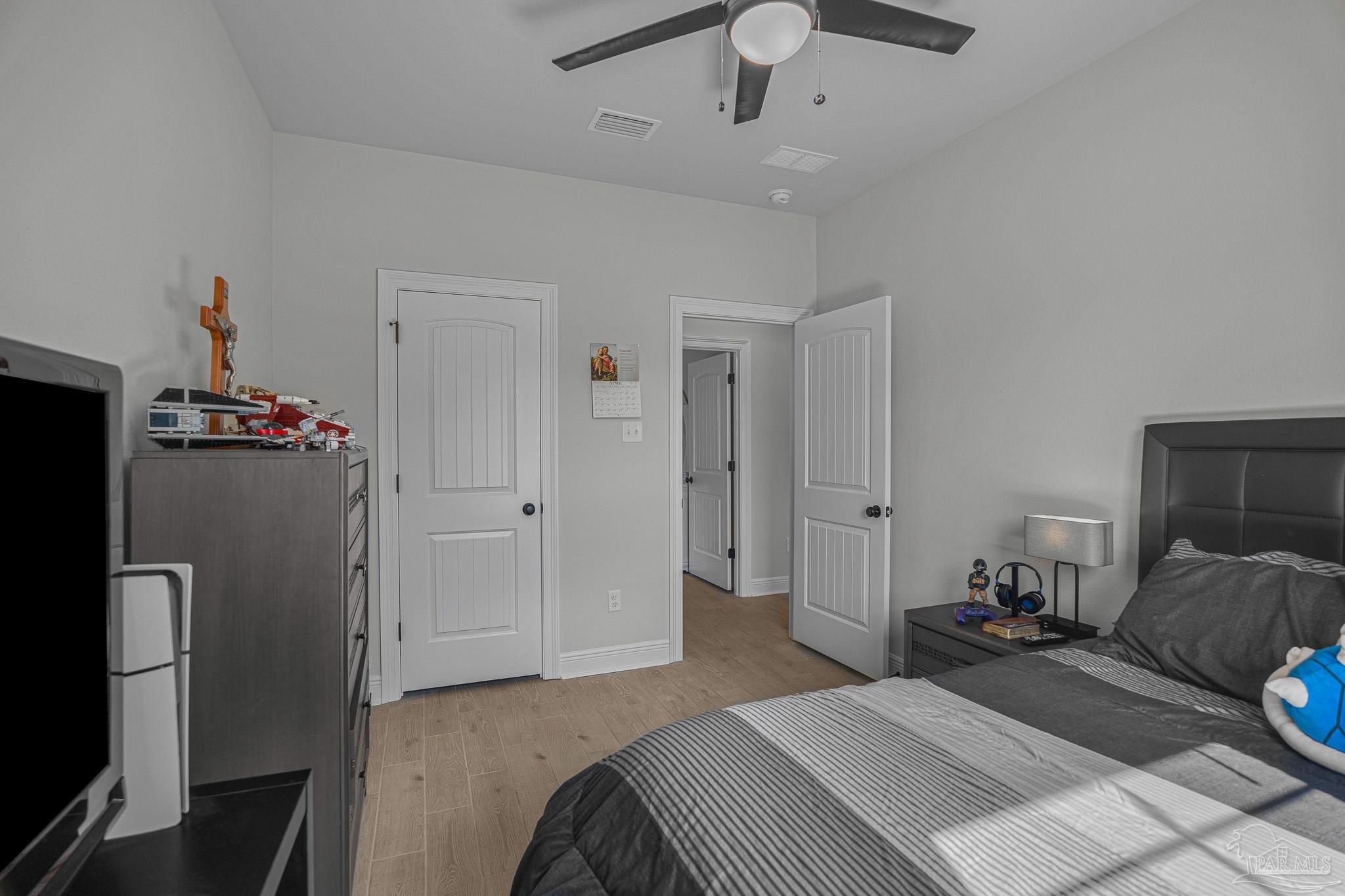 5380 Adeline Circle Pace, FL 32571 - Photo 24 of 35 a bedroom with a bed and a chandelier