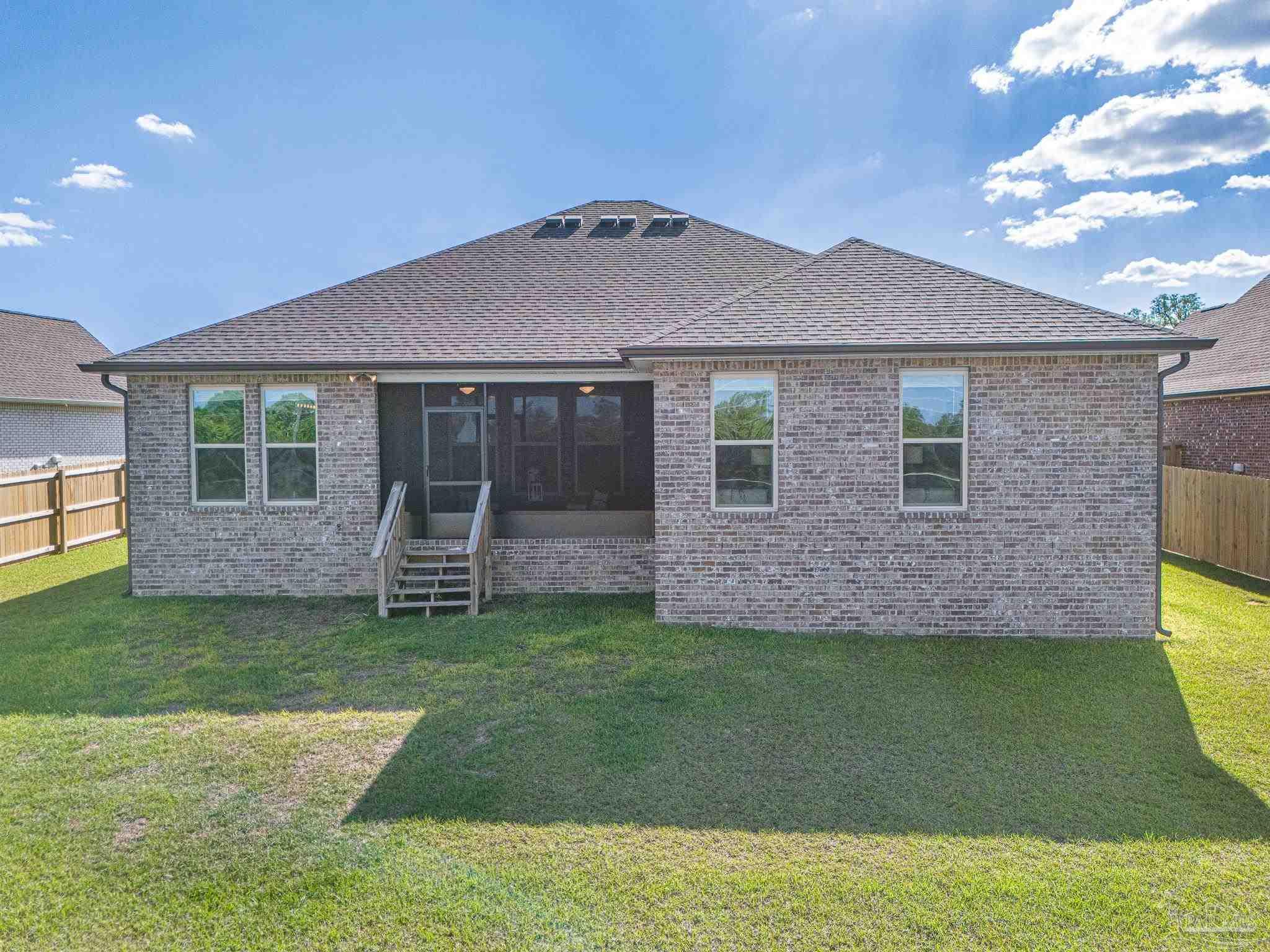 5380 Adeline Circle Pace, FL 32571 - Photo 29 of 35 a front view of a house with a garden