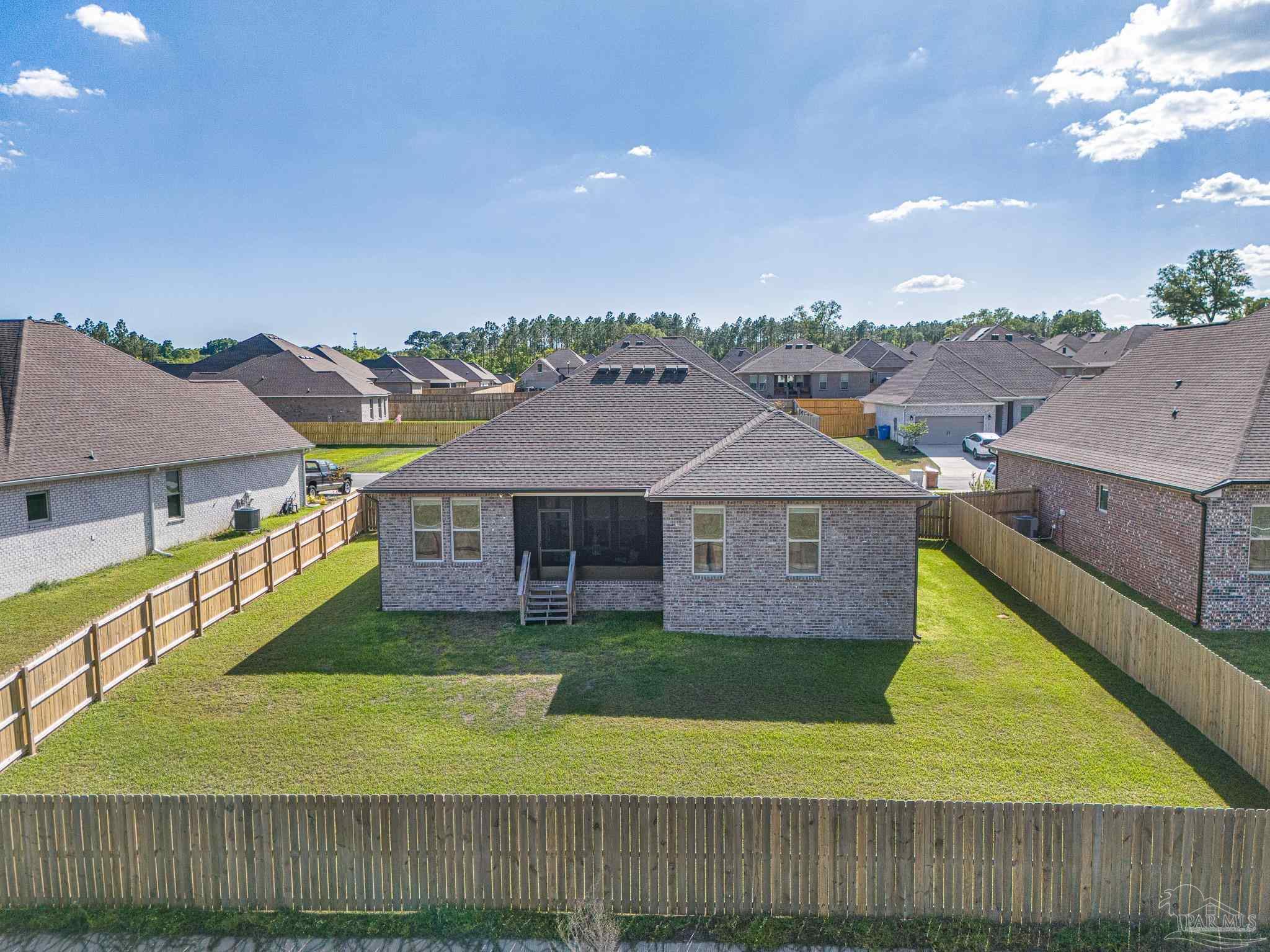 5380 Adeline Circle Pace, FL 32571 - Photo 30 of 35 a aerial view of a house next to a big yard