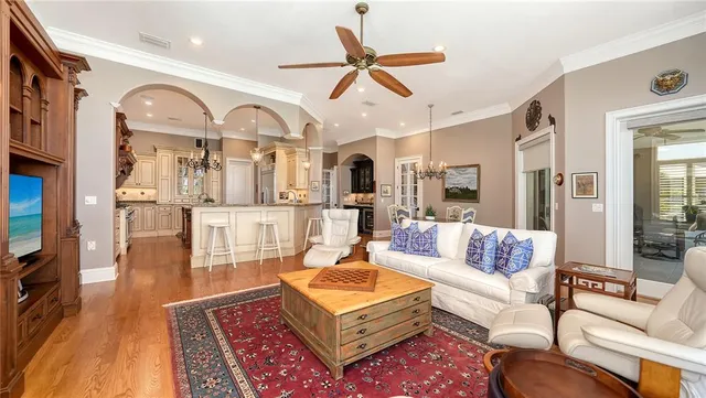 a living room with fireplace furniture and a large window