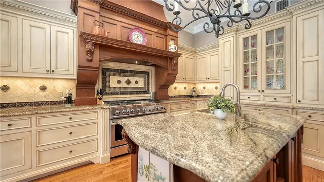 a bedroom with a large bed and a chandelier