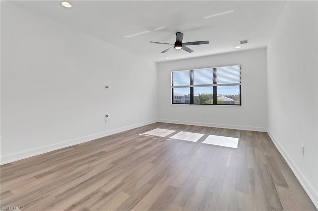 20458 Fair Oak Lane Estero, FL 33928 - Photo 16 of 40 Spare room with ceiling fan and light wood-type flooring