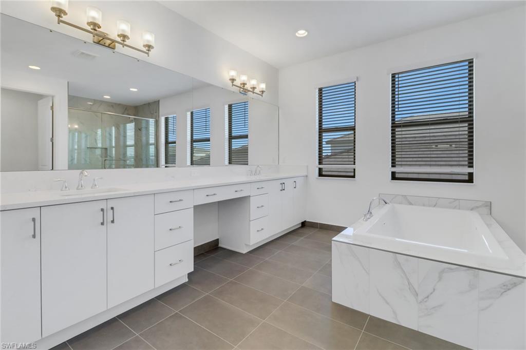20458 Fair Oak Lane Estero, FL 33928 - Photo 20 of 40 Bathroom with tile patterned floors, vanity, and independent shower and bath