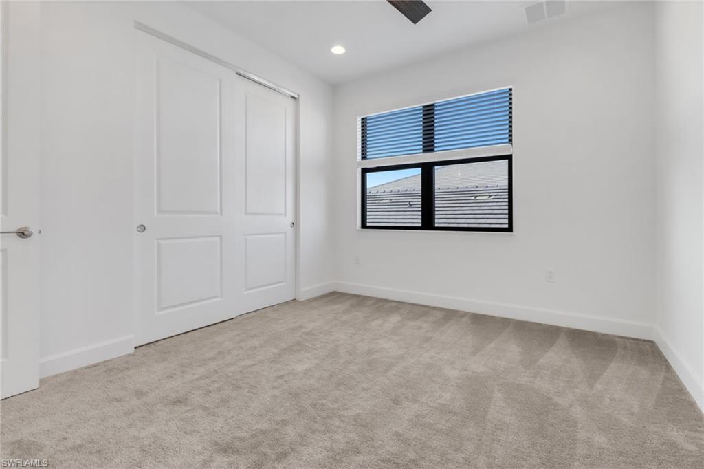 20458 Fair Oak Lane Estero, FL 33928 - Photo 23 of 40 Unfurnished bedroom with light colored carpet, a closet, and ceiling fan