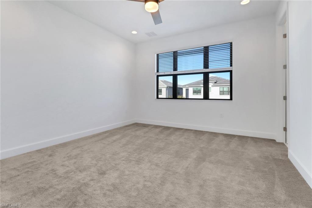 20458 Fair Oak Lane Estero, FL 33928 - Photo 25 of 40 Spare room with ceiling fan and light colored carpet