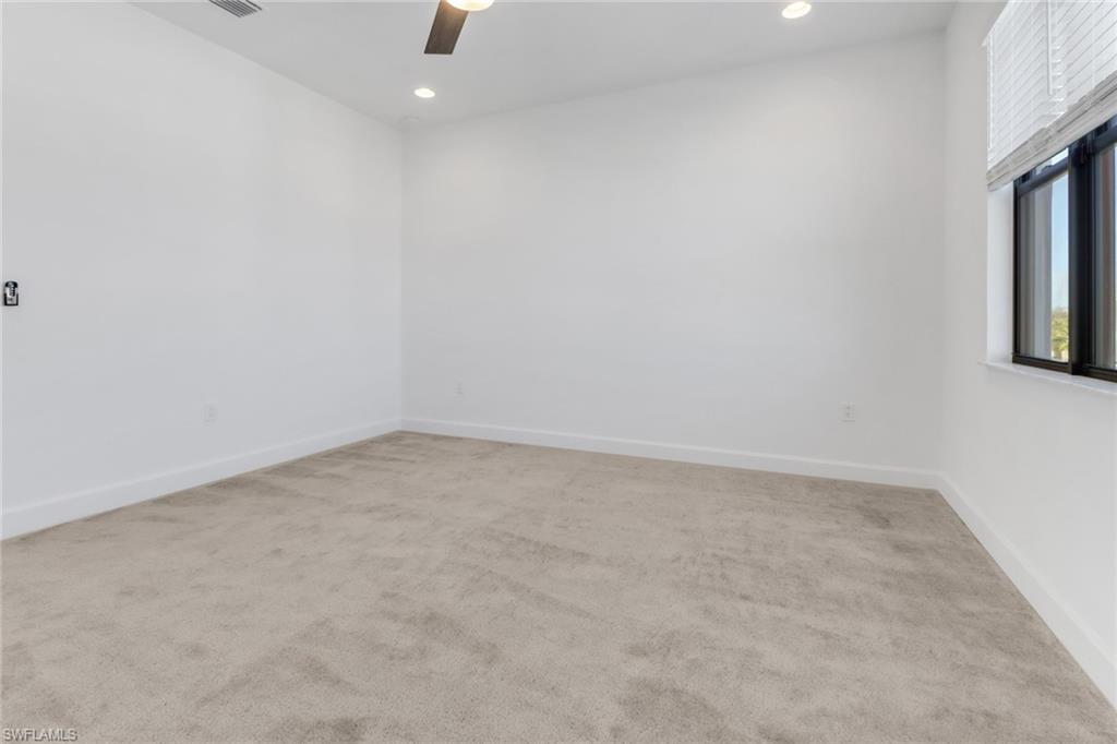 20458 Fair Oak Lane Estero, FL 33928 - Photo 26 of 40 Empty room with carpet flooring and ceiling fan