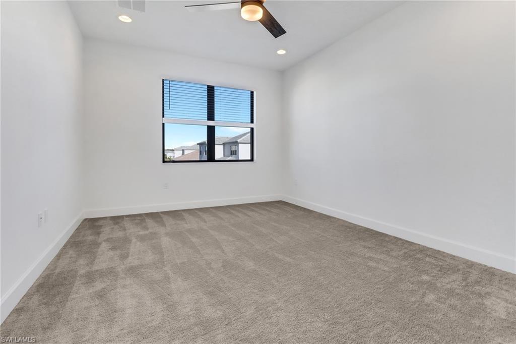 20458 Fair Oak Lane Estero, FL 33928 - Photo 28 of 40 Spare room featuring ceiling fan and light colored carpet