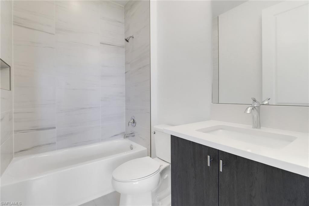 20458 Fair Oak Lane Estero, FL 33928 - Photo 30 of 40 Full bathroom with toilet, vanity, and tiled shower / bath
