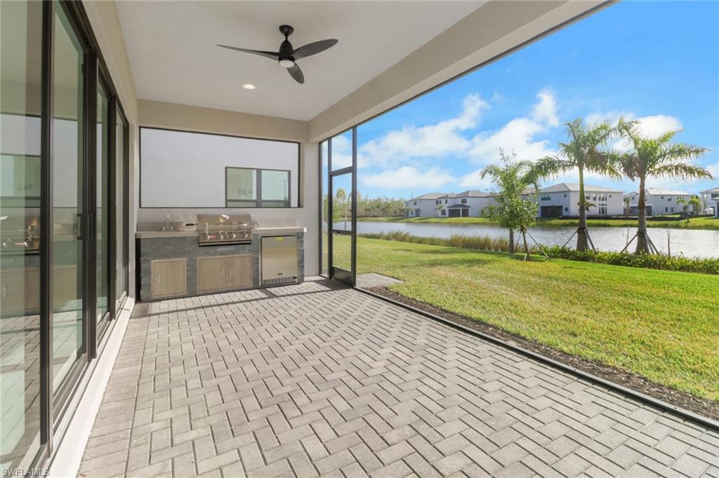 20458 Fair Oak Lane Estero, FL 33928 - Photo 32 of 40 Unfurnished sunroom with ceiling fan and a water view