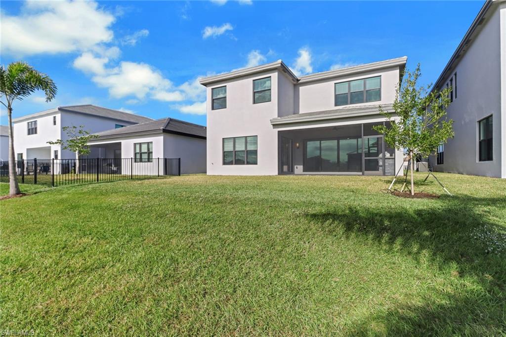 20458 Fair Oak Lane Estero, FL 33928 - Photo 35 of 40 Back of property with a yard and a sunroom