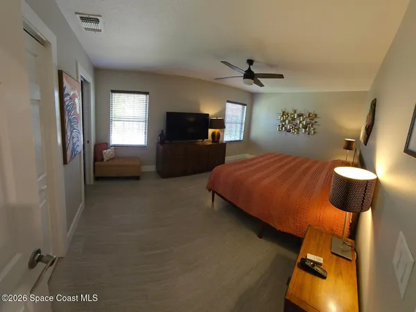 a bedroom with a bed and a couch