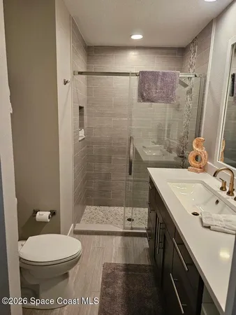 a bathroom with a sink toilet and shower