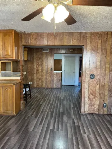 a kitchen with a wooden floor and breakfast area