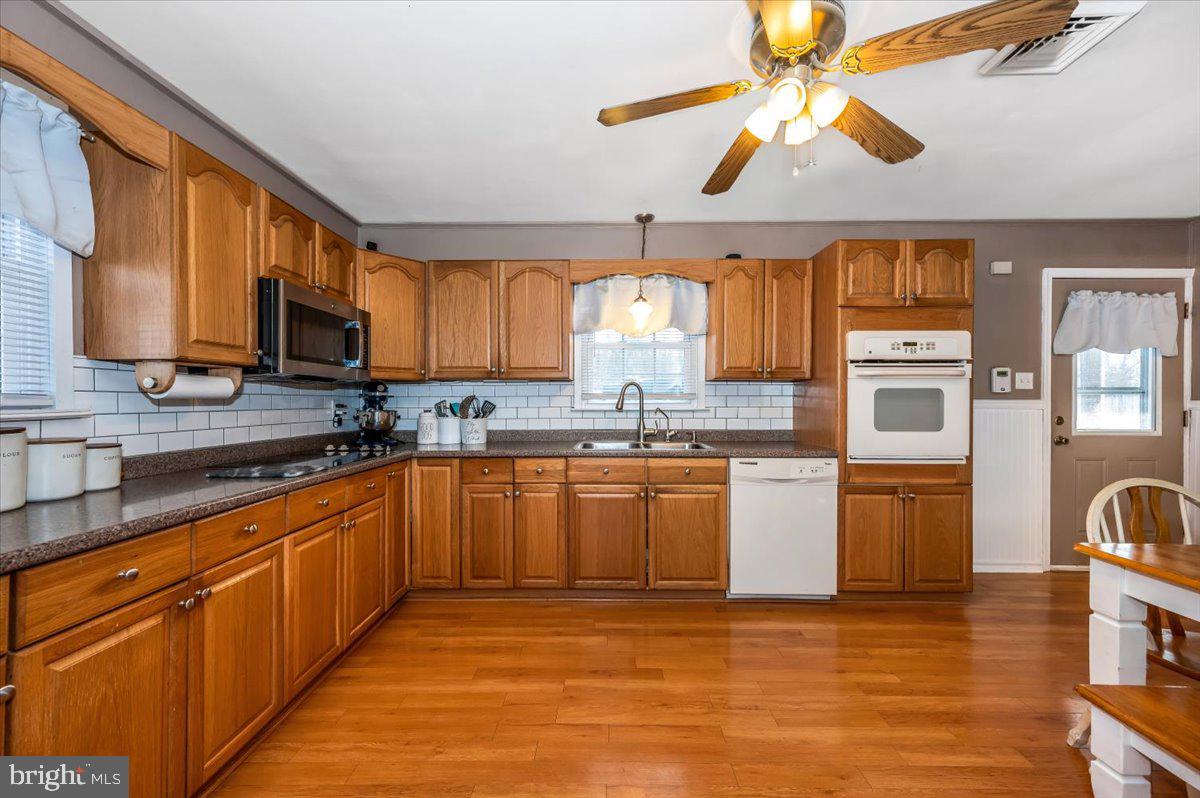 15225 Clear Spring Road Williamsport, MD 21795 - Photo 12 of 44 a large kitchen with stainless steel appliances granite countertop a stove cabinets and a sink
