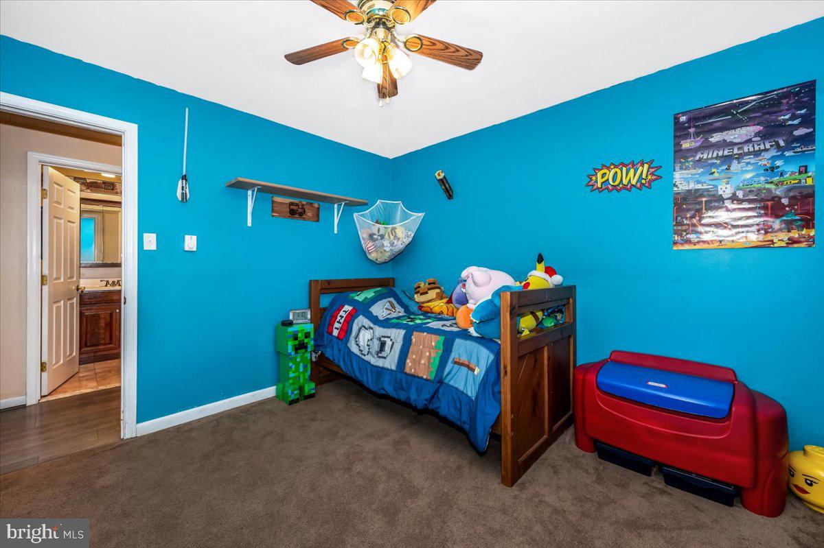 15225 Clear Spring Road Williamsport, MD 21795 - Photo 20 of 44 a bedroom with a bed and a chandelier