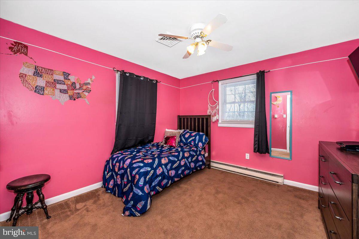 15225 Clear Spring Road Williamsport, MD 21795 - Photo 21 of 44 a bedroom with a bed and a chandelier