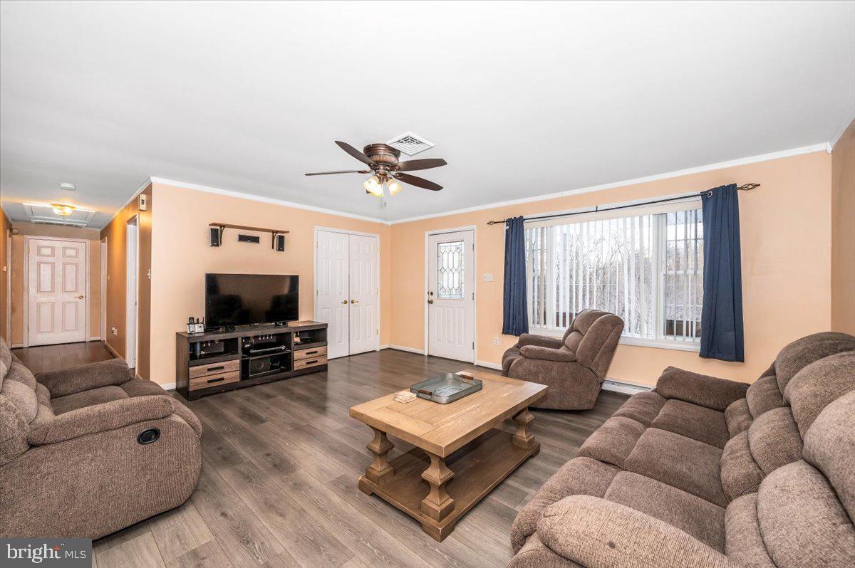 15225 Clear Spring Road Williamsport, MD 21795 - Photo 6 of 44 a living room with furniture a flat screen tv and a large window