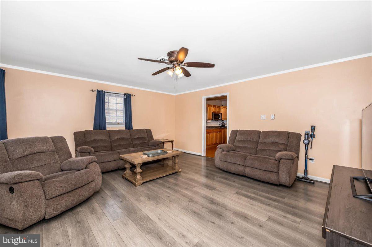 15225 Clear Spring Road Williamsport, MD 21795 - Photo 7 of 44 a living room with furniture ceiling fan and a wooden floor