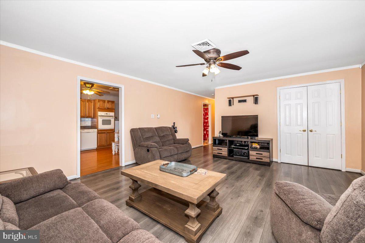 15225 Clear Spring Road Williamsport, MD 21795 - Photo 8 of 44 a living room with furniture a flat screen tv and a refrigerator