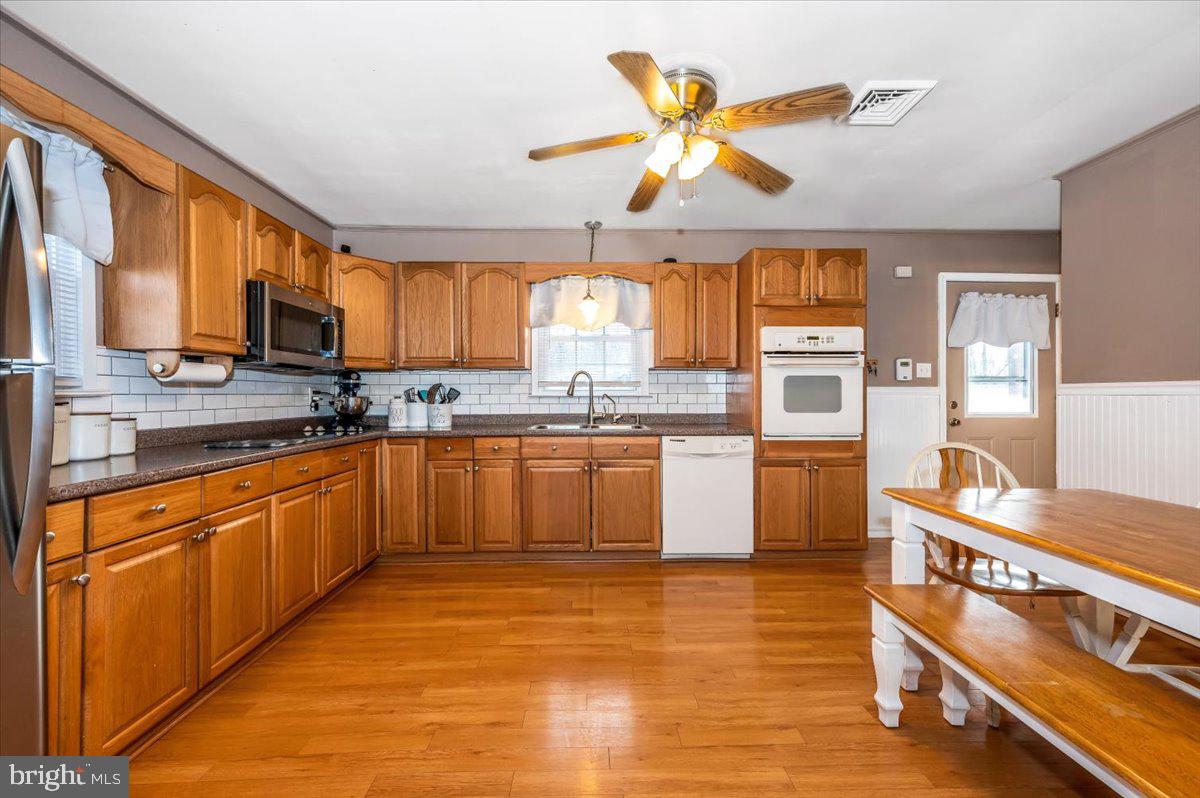 15225 Clear Spring Road Williamsport, MD 21795 - Photo 9 of 44 a kitchen with stainless steel appliances granite countertop a stove sink and cabinets