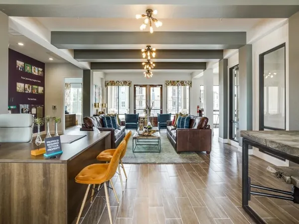 a view of a dining room with furniture a chandelier and wooden floor