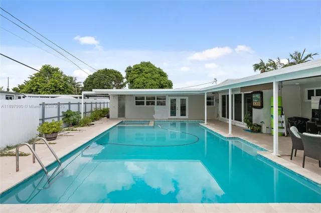 a view of house with swimming pool outdoor seating