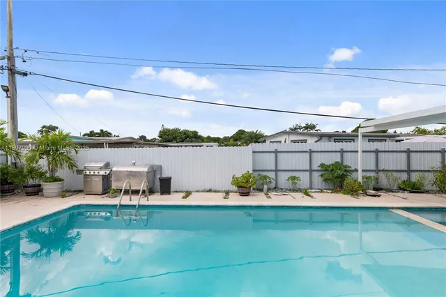 a living room filled with lots of potted plants