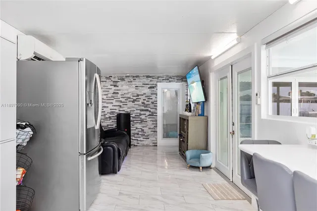 a room with a couch and a refrigerator