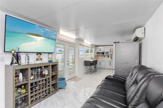a living room with furniture cabinets and window