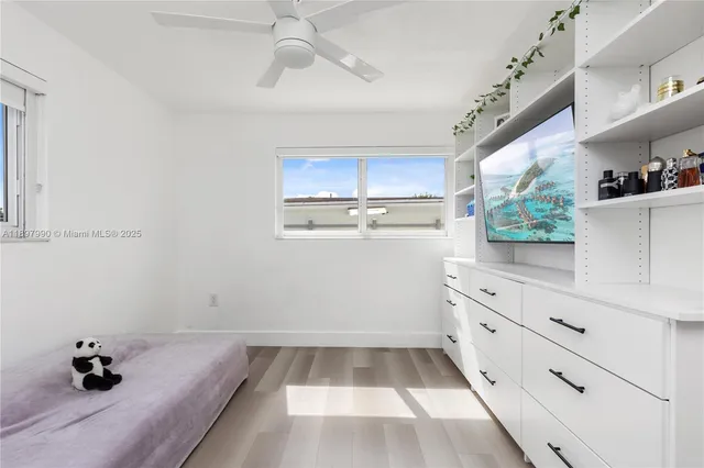 a kitchen with a white cabinets and window