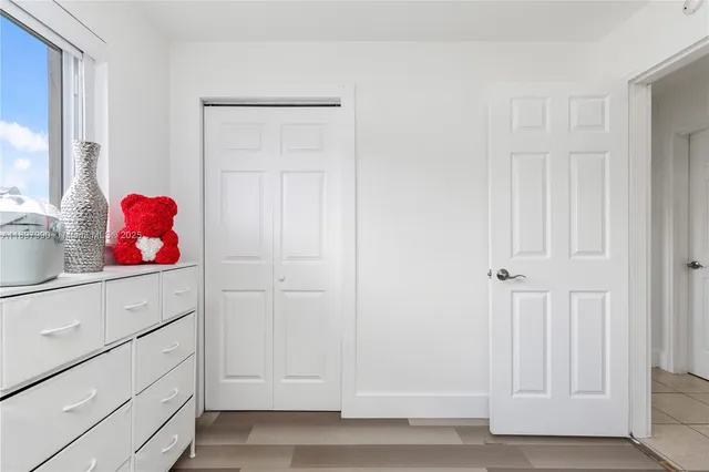 a view of an entryway with cabinet