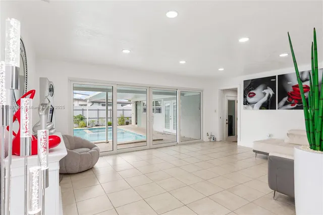 a bedroom with furniture and a large window