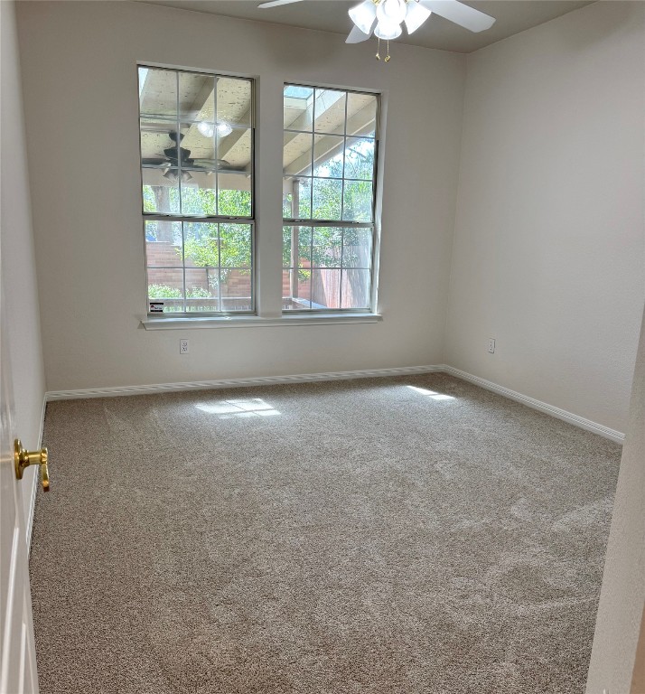 6319 Zadock Woods Drive Austin, TX 78749 - Photo 15 of 39 an empty room with windows and chandelier fan