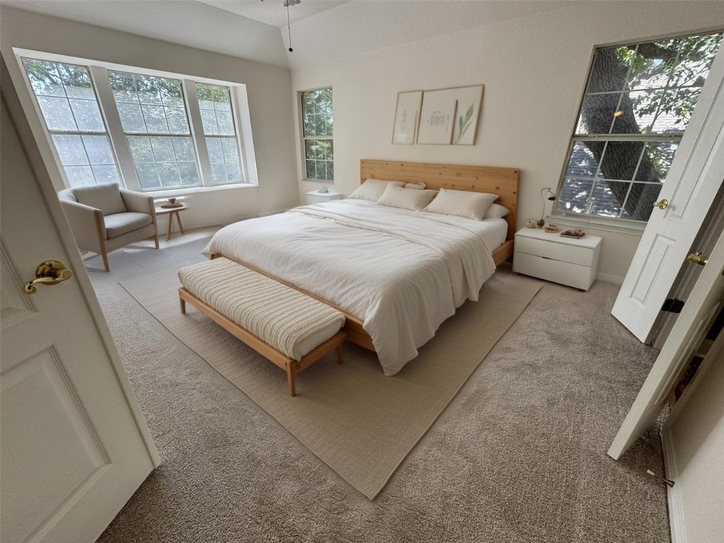 6319 Zadock Woods Drive Austin, TX 78749 - Photo 19 of 39 a spacious bedroom with a bed couch and a window