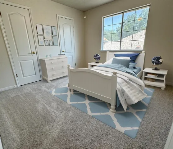 a living room with stainless steel appliances furniture and a window