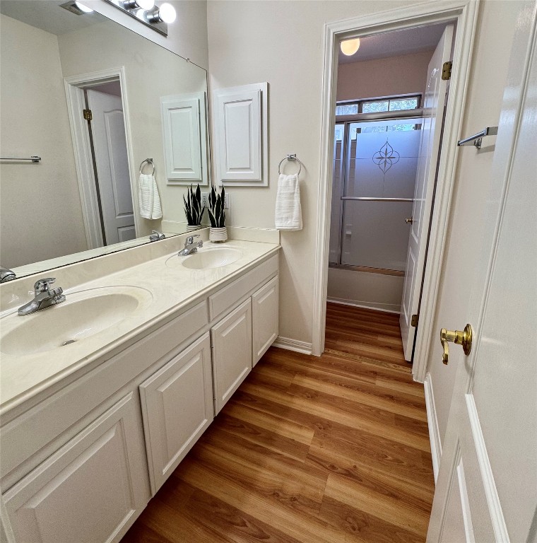6319 Zadock Woods Drive Austin, TX 78749 - Photo 28 of 39 a bathroom with a double vanity sink and mirror