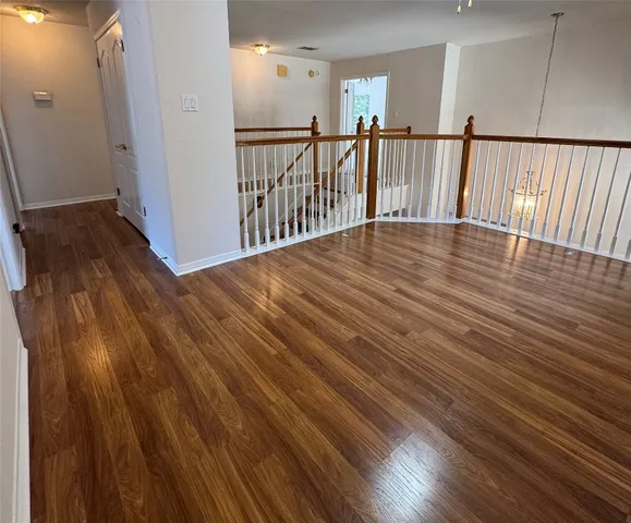wooden floor with view of entryway