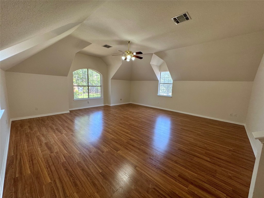 6319 Zadock Woods Drive Austin, TX 78749 - Photo 31 of 39 an empty room with wooden floor and windows
