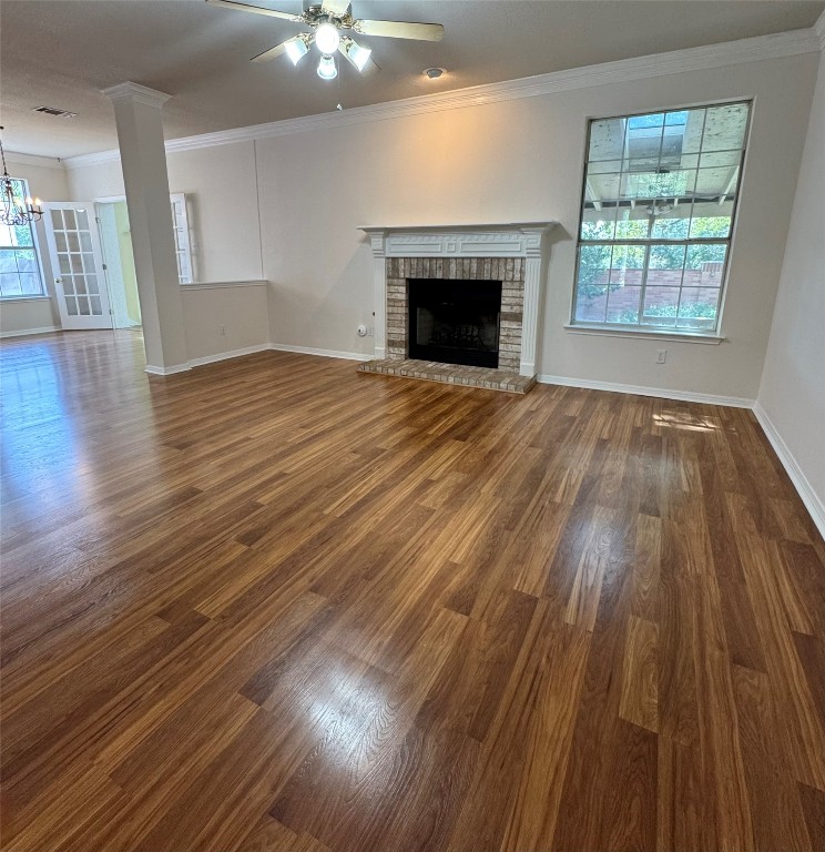 6319 Zadock Woods Drive Austin, TX 78749 - Photo 7 of 39 an empty room with wooden floor fireplace and windows