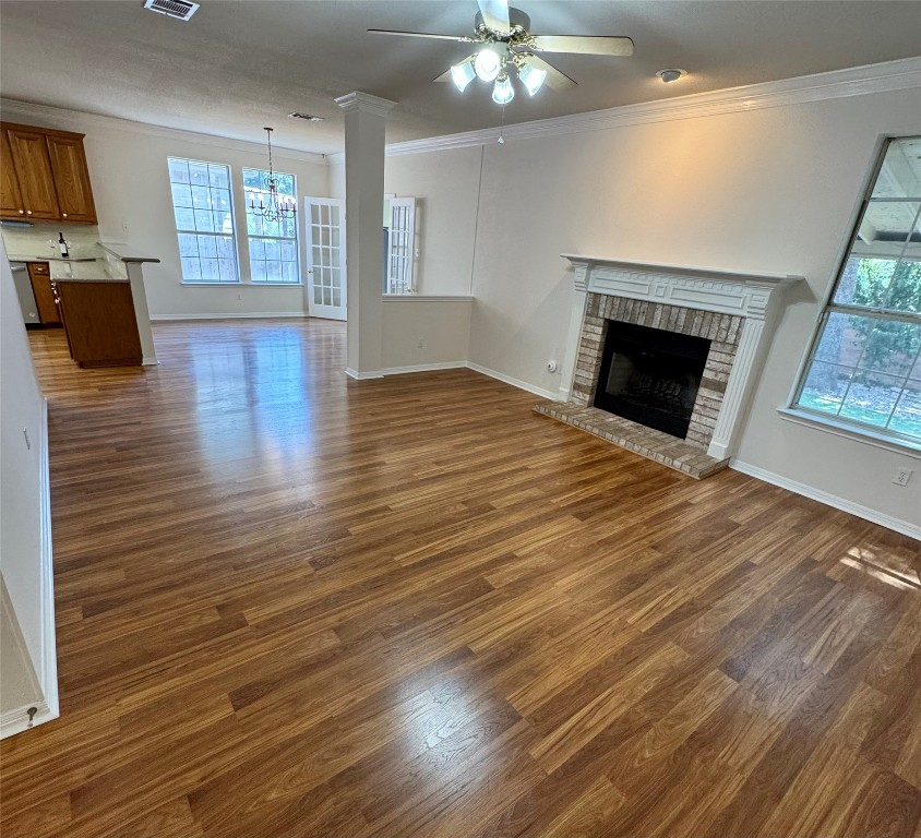 6319 Zadock Woods Drive Austin, TX 78749 - Photo 8 of 39 an empty room with wooden floor fireplace and windows